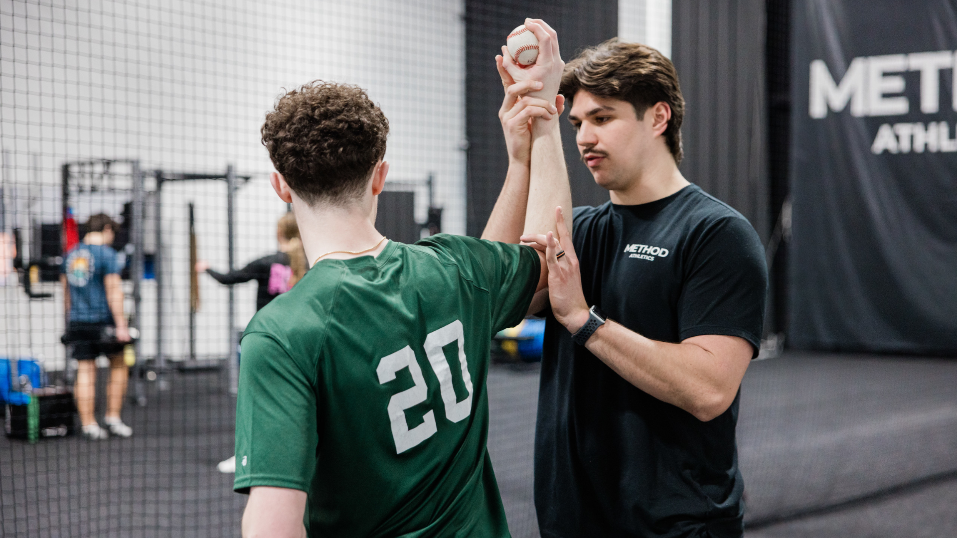 Youth athlete working with a Method Athletics coach on throwing mechanics